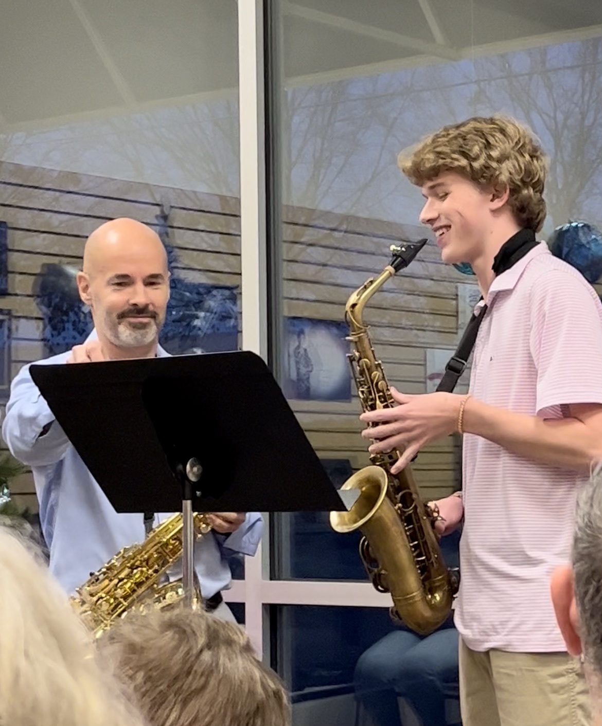 Scott Brady teaching a saxophone student as they play together at a music stand